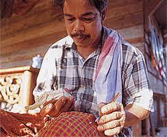 Nik Rashiddin Nik Hussein carving intricate wooden designs
